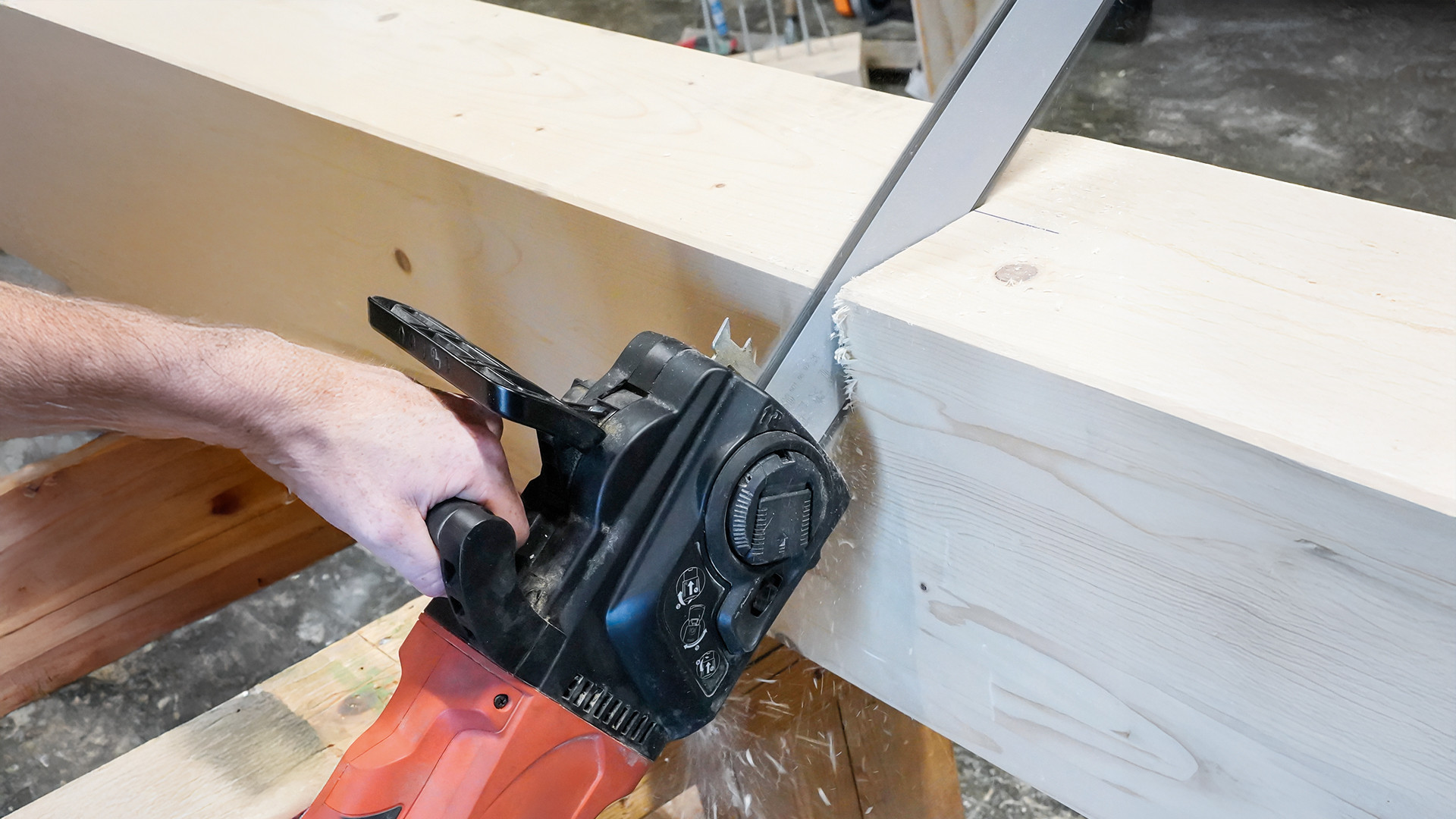 Professional woodworking machine cutting a solid timber beam with a woodworking chainsaw, used in structural timber carpentry